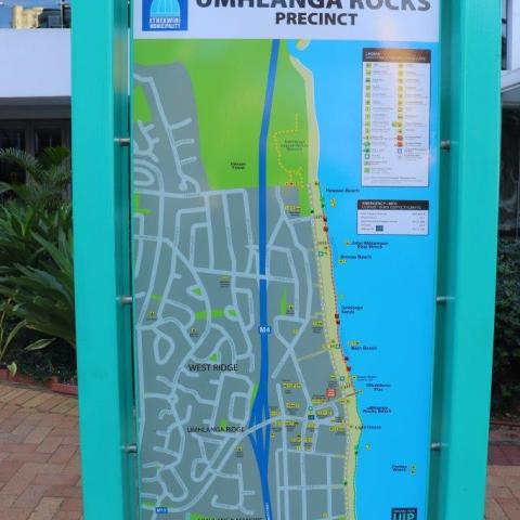 Colorful map of Umhlanga Rocks Precinct on a teal stand.
