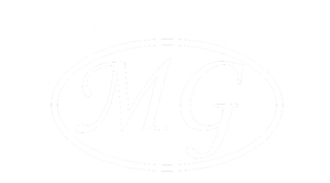 Faint logo with letters 'MG' inside an oval shape.